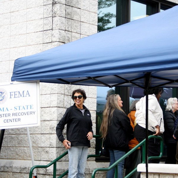 People gather at a FEMA Disaster Recovery Center at A.C. Reynolds High School in Asheville, N.C.,, Tuesday, Oct. 15, 2024. (AP Photo/Makiya Seminera)