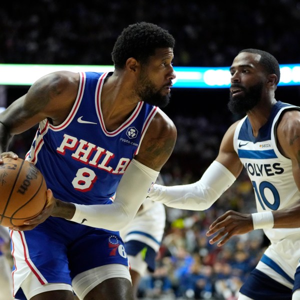 Philadelphia 76ers forward Paul George (8) looks to drive around Minnesota Timberwolves guard Mike Conley (10) during the first half of an NBA preseason basketball game, Friday, Oct. 11, 2024, in Des Moines, Iowa. (AP Photo/Charlie Neibergall)