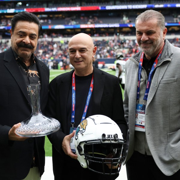 Jaguars owner Shahid Khan, Tottenham chairman Daniel Levy and Spurs head coach Ange Postecoglou, from left, pose for a photo before an NFL football game at the Tottenham Hotspur stadium between the Jacksonville Jaguars and Chicago Bears in London, Sunday, Oct. 13, 2024. (AP Photo/Ian Walton)