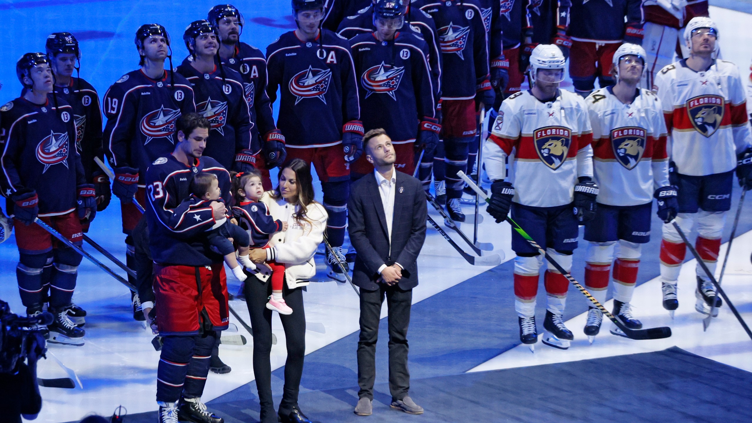 Blue Jackets' Johnny Gaudreau's family watches a #13 banner being raised during a ceremony before the start of an NHL hockey game between the Columbus Blue Jackets and the Florida Panthers. Tuesday, Oct. 15, 2024, in Columbus, Ohio. (AP Photo/Jay LaPrete)