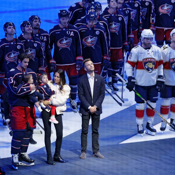 Blue Jackets' Johnny Gaudreau's family watches a #13 banner being raised during a ceremony before the start of an NHL hockey game between the Columbus Blue Jackets and the Florida Panthers. Tuesday, Oct. 15, 2024, in Columbus, Ohio. (AP Photo/Jay LaPrete)