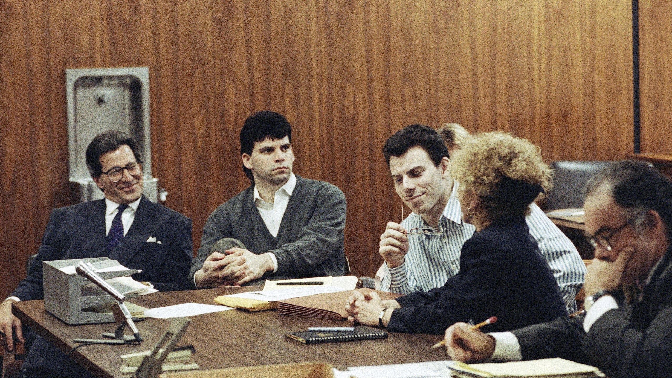 FILE - Erik Menendez, center, listens to his attorney Leslie Abramson, as his brother Lyle looks on in a Beverly Hills, California, May 17, 1991. (AP Photo/Julie Markes, File)