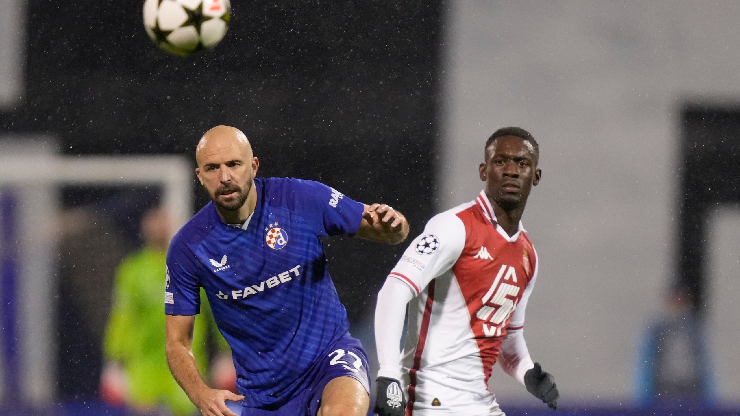 Dinamo's goalkeeper Ivan Filipovic, left, and Monaco's Folarin Balogun go for the ball during the Champions League soccer match between Dinamo Zagreb and Monaco at Maksimir stadium in Zagreb, Croatia, Wednesday, Oct. 2, 2024. (AP Photo/Darko Bandic)