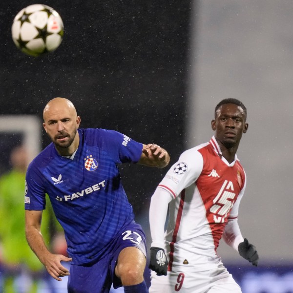 Dinamo's goalkeeper Ivan Filipovic, left, and Monaco's Folarin Balogun go for the ball during the Champions League soccer match between Dinamo Zagreb and Monaco at Maksimir stadium in Zagreb, Croatia, Wednesday, Oct. 2, 2024. (AP Photo/Darko Bandic)