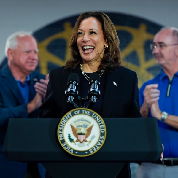 FILE - Democratic presidential nominee Vice President Kamala Harris, with Democratic vice presidential nominee Minnesota Gov. Tim Walz, left, and UAW President Shawn Fain, speaks at a campaign rally at UAW Local 900, Aug. 8, 2024, in Wayne, Mich. (AP Photo/Julia Nikhinson, File)