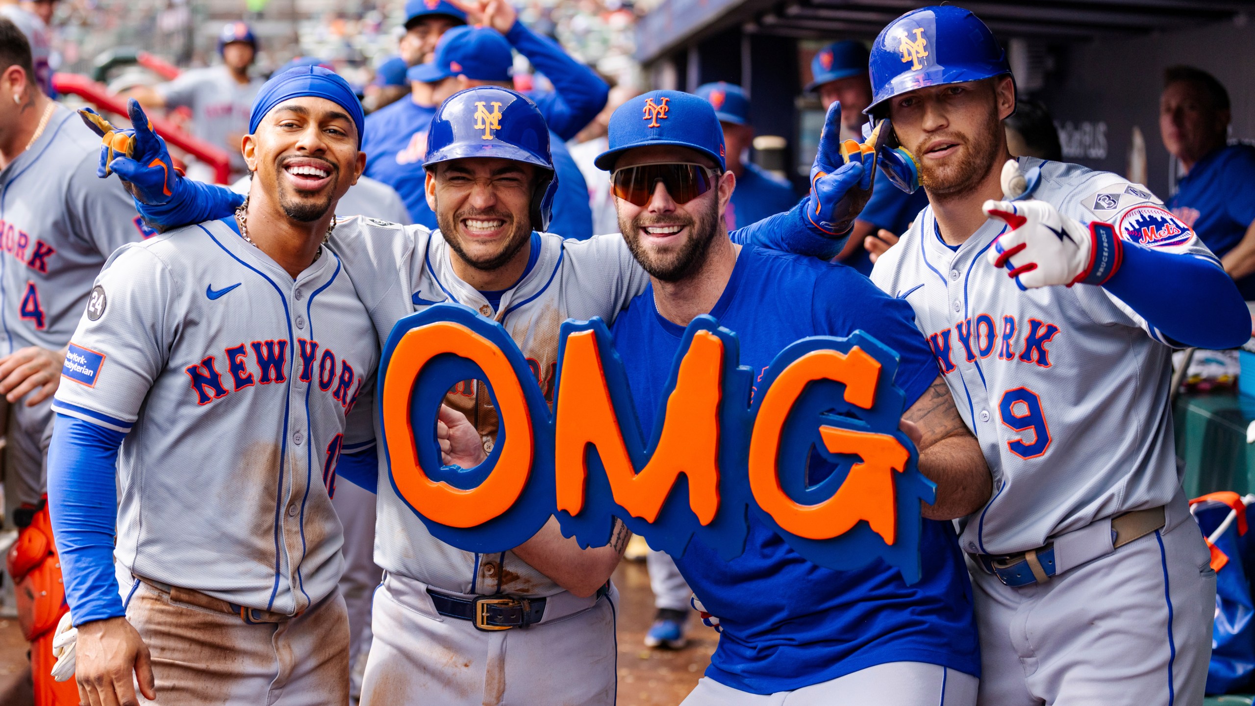 New York Mets' Francisco Lindor, left, Jose Iglesias, left center, David Peterson, right center, and Brandon Nimmo, right, celebrate in the dugout after taking the lead in the eighth inning of a baseball game against the Atlanta Braves, Monday, Sept. 30, 2024, in Atlanta. (AP Photo/Jason Allen)