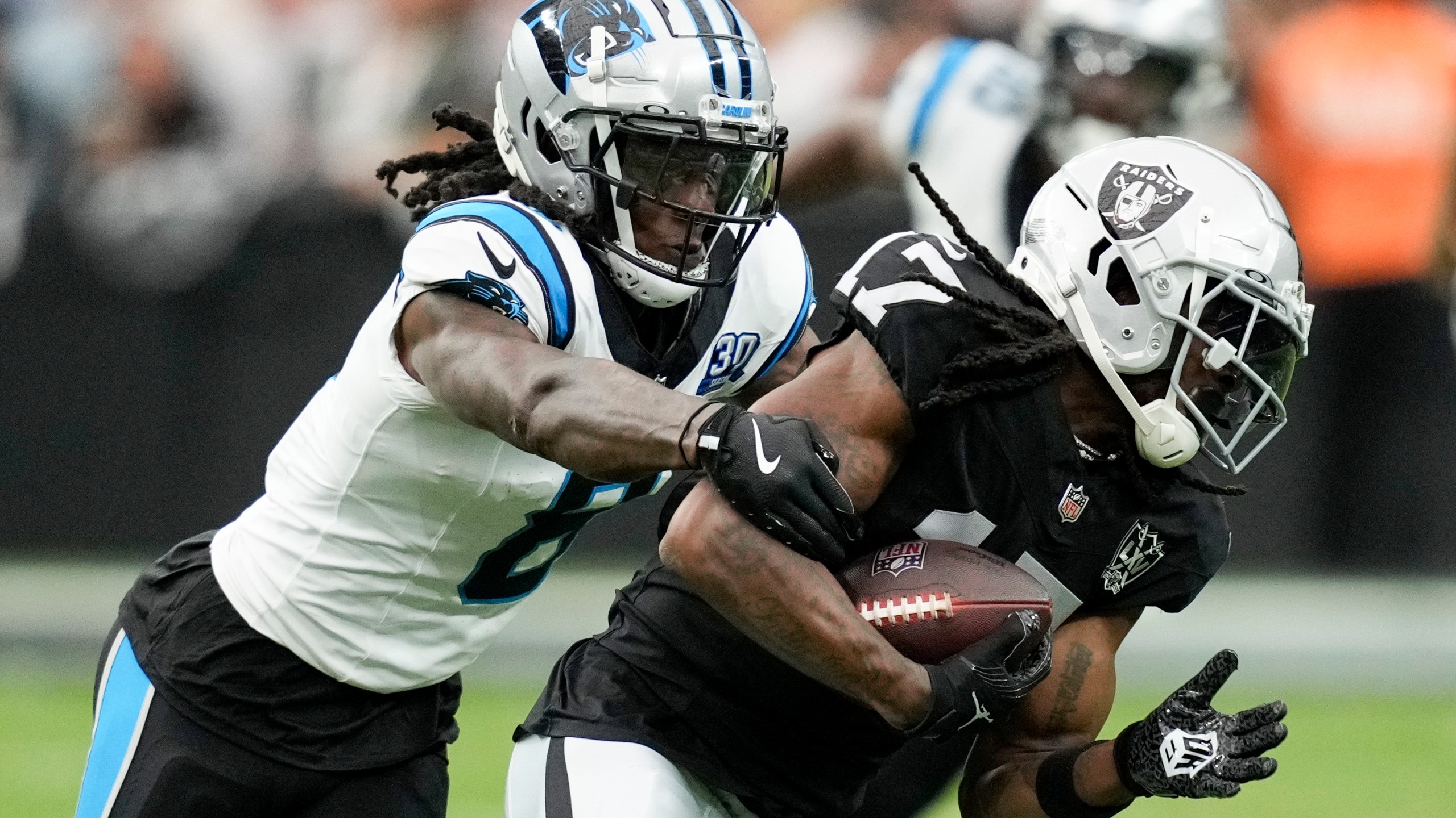 Las Vegas Raiders wide receiver Davante Adams is tackled by Carolina Panthers cornerback Jaycee Horn during the first half of an NFL football game, Sunday, Sept. 22, 2024, in Las Vegas. (AP Photo/John Locher)