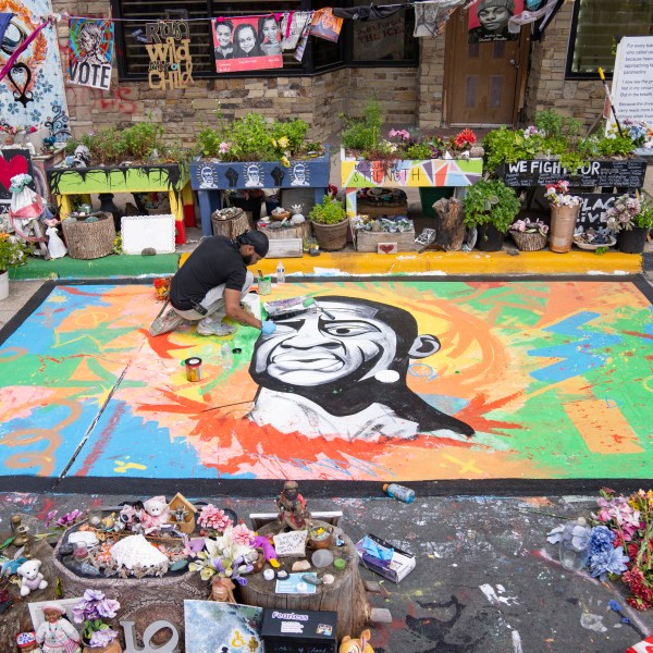 FILE - Antonio Jenkins paints a mural of George Floyd at the site where he was murdered by a police officer in 2020 at George Floyd Square in Minneapolis, May 25, 2024. (Alex Kormann/Star Tribune via AP, File)