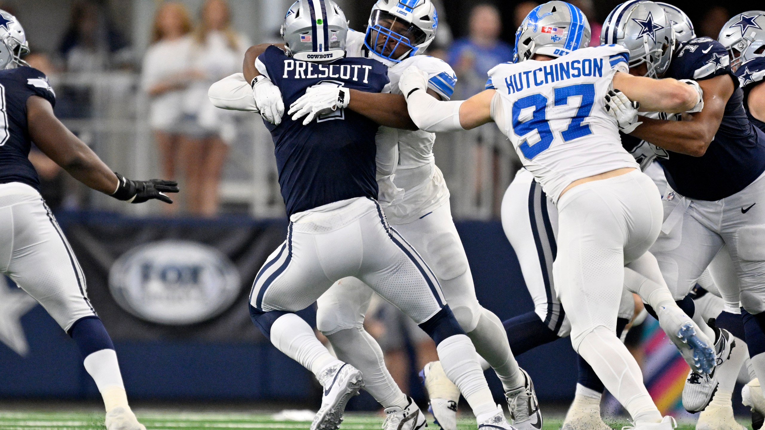 Dallas Cowboys quarterback Dak Prescott (4) is sacked by Detroit Lions defensive tackle Alim McNeill, rear, with pressure from Aidan Hutchinson (97) in the first half of an NFL football game in Arlington, Texas, Sunday, Oct. 13, 2024. (AP Photo/Jerome Miron)