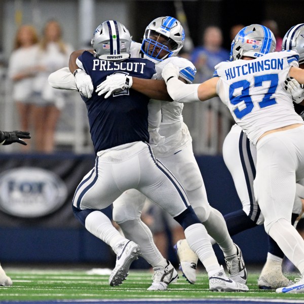 Dallas Cowboys quarterback Dak Prescott (4) is sacked by Detroit Lions defensive tackle Alim McNeill, rear, with pressure from Aidan Hutchinson (97) in the first half of an NFL football game in Arlington, Texas, Sunday, Oct. 13, 2024. (AP Photo/Jerome Miron)