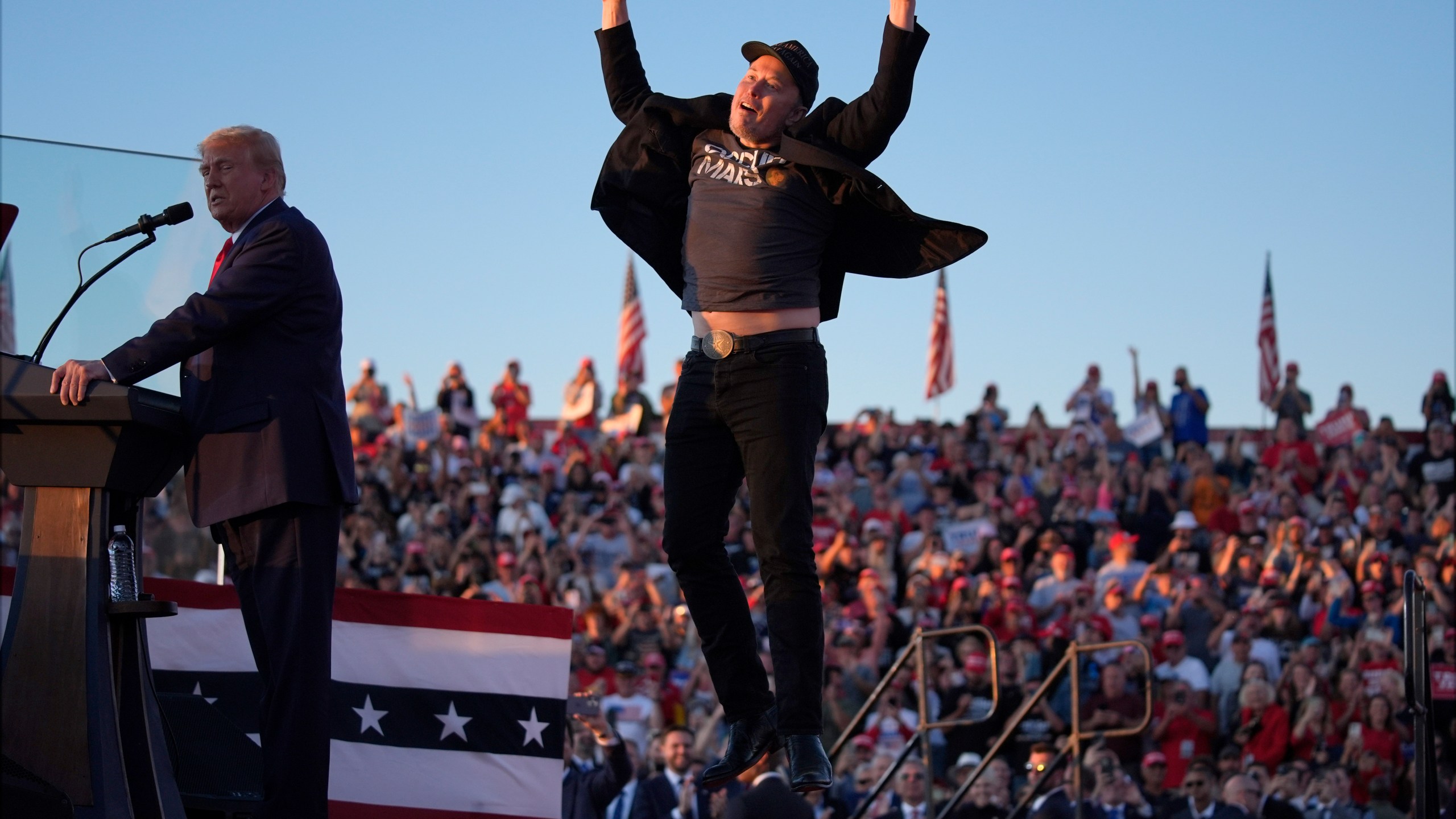 Elon Musk jumps on the stage as Republican presidential nominee former President Donald Trump speaks at a campaign rally at the Butler Farm Show, Saturday, Oct. 5, 2024, in Butler, Pa. (AP Photo/Evan Vucci)