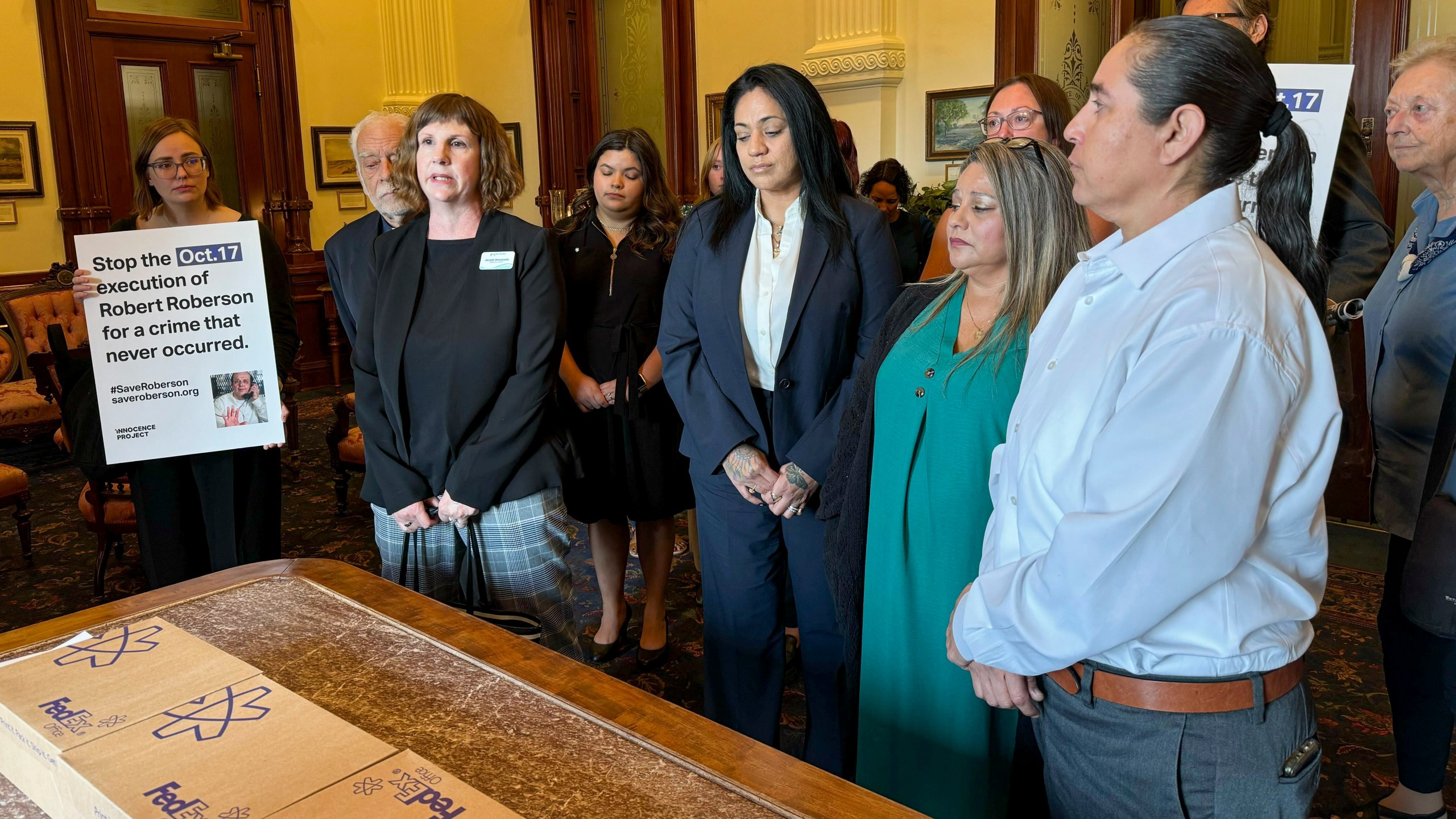 Elizabeth Ramirez, center, Casandra Rivera, center right, and Anna Vasquez, second from right, of the "San Antonio 4" group, deliver boxes with petitions in the Texas State capitol for Texas Gov. Greg Abbott seeking the pardoning of Robert Roberson's execution, Wednesday, Oct. 16, 2024, in Austin, Texas. Roberson, 57, is scheduled to receive a lethal injection on Oct. 17, for the 2002 killing of his 2-year-old daughter, Nikki Curtis, in the East Texas city of Palestine. Roberson has long proclaimed his innocence. (AP Photo/Nadia Lathan)