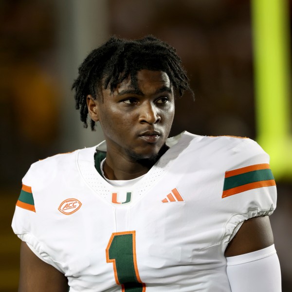 FILE - Miami quarterback Cam Ward (1) warms up before an NCAA college football game against California in Berkeley, Calif., Oct. 5, 2024. (AP Photo/Jed Jacobsohn, File)