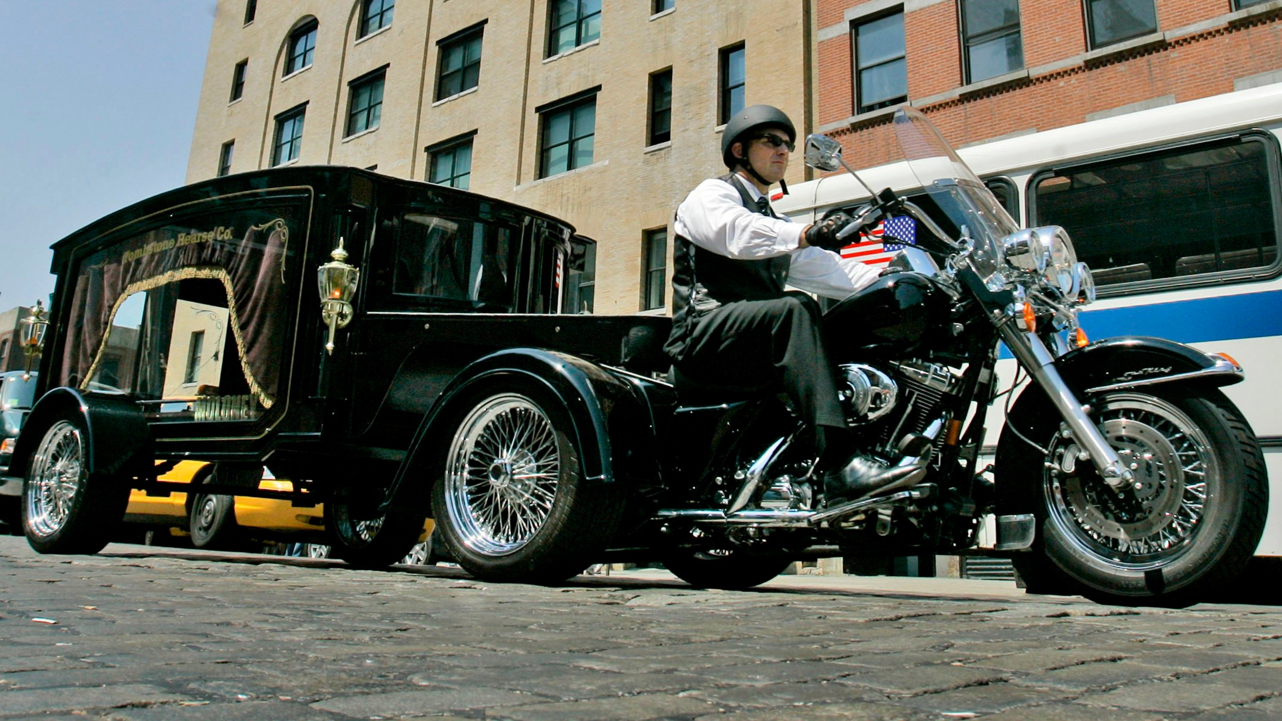 FILE — Peter Moloney, of Moloney Family Funeral Homes in Lake Ronkonkoma, N.Y., rides his Harley Davidson hearse from the Tombstone Hearse Co. of Alum Bank, Pa., in New York, May 24, 2007. (AP Photo/Richard Drew, File)