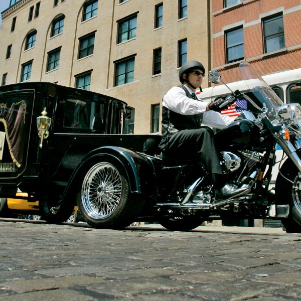 FILE — Peter Moloney, of Moloney Family Funeral Homes in Lake Ronkonkoma, N.Y., rides his Harley Davidson hearse from the Tombstone Hearse Co. of Alum Bank, Pa., in New York, May 24, 2007. (AP Photo/Richard Drew, File)