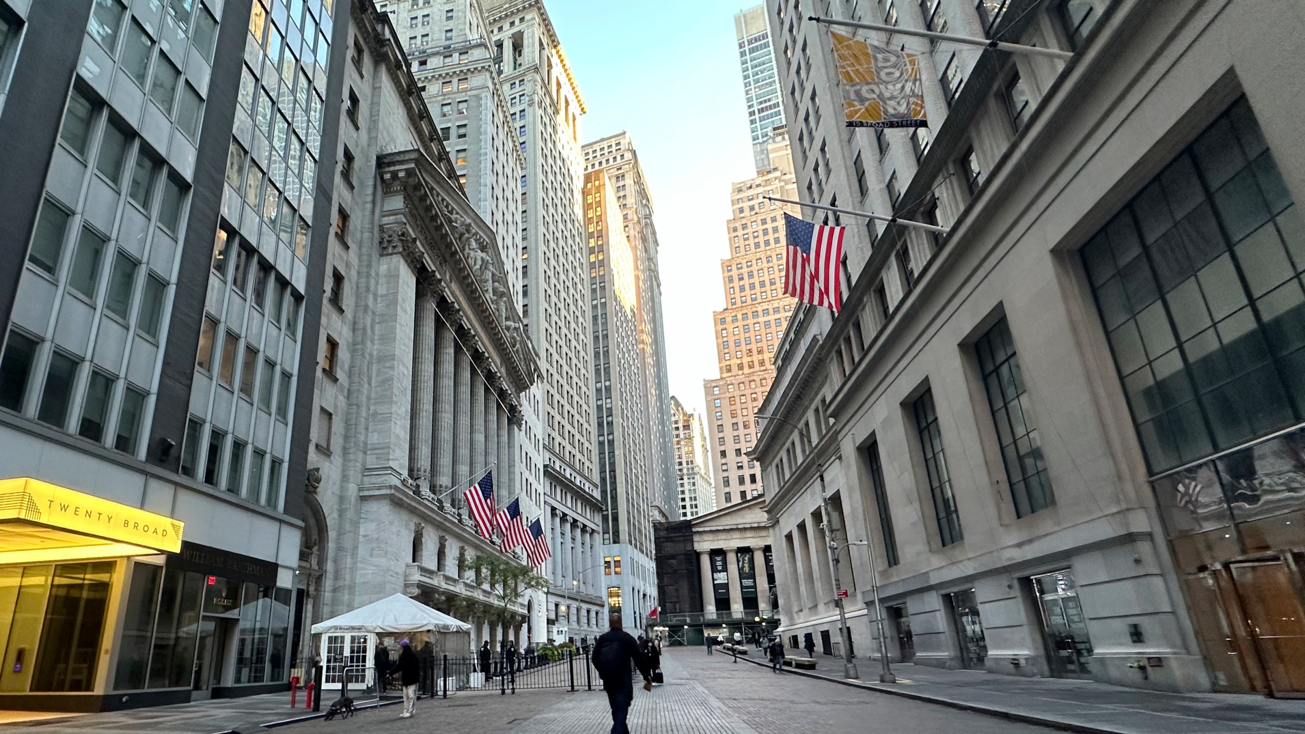 FILE - American flags, left, hang from the New York Stock Exchange on Oct. 16, 2024, in New York. (AP Photo/Peter Morgan, File)