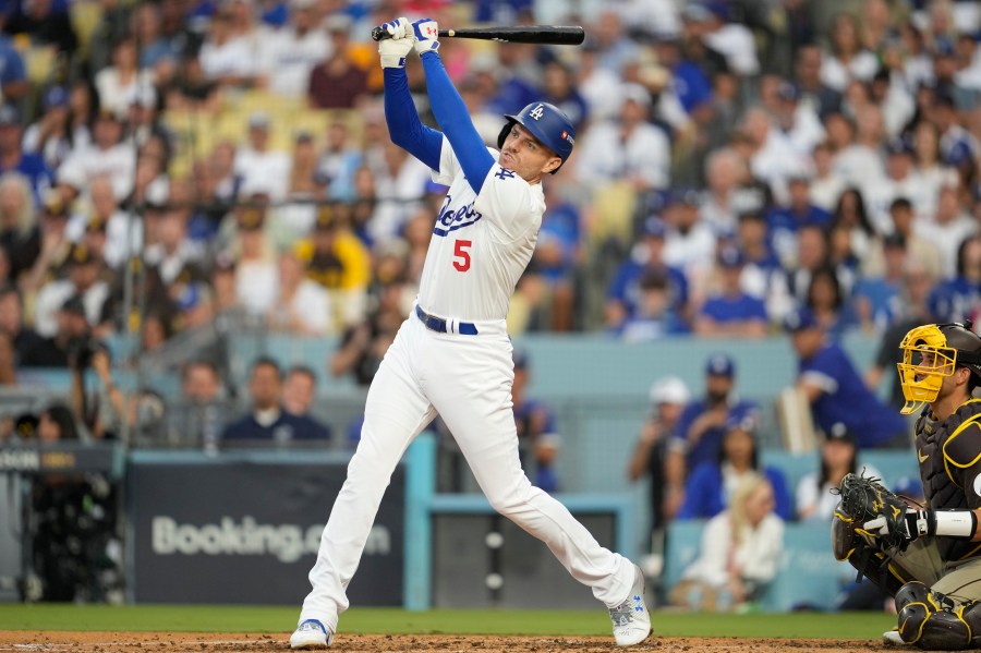 Los Angeles Dodgers' Freddie Freeman flies out during the fourth inning in Game 5 of a baseball NL Division Series against the San Diego Padres, Friday, Oct. 11, 2024, in Los Angeles. (AP Photo/Ashley Landis)