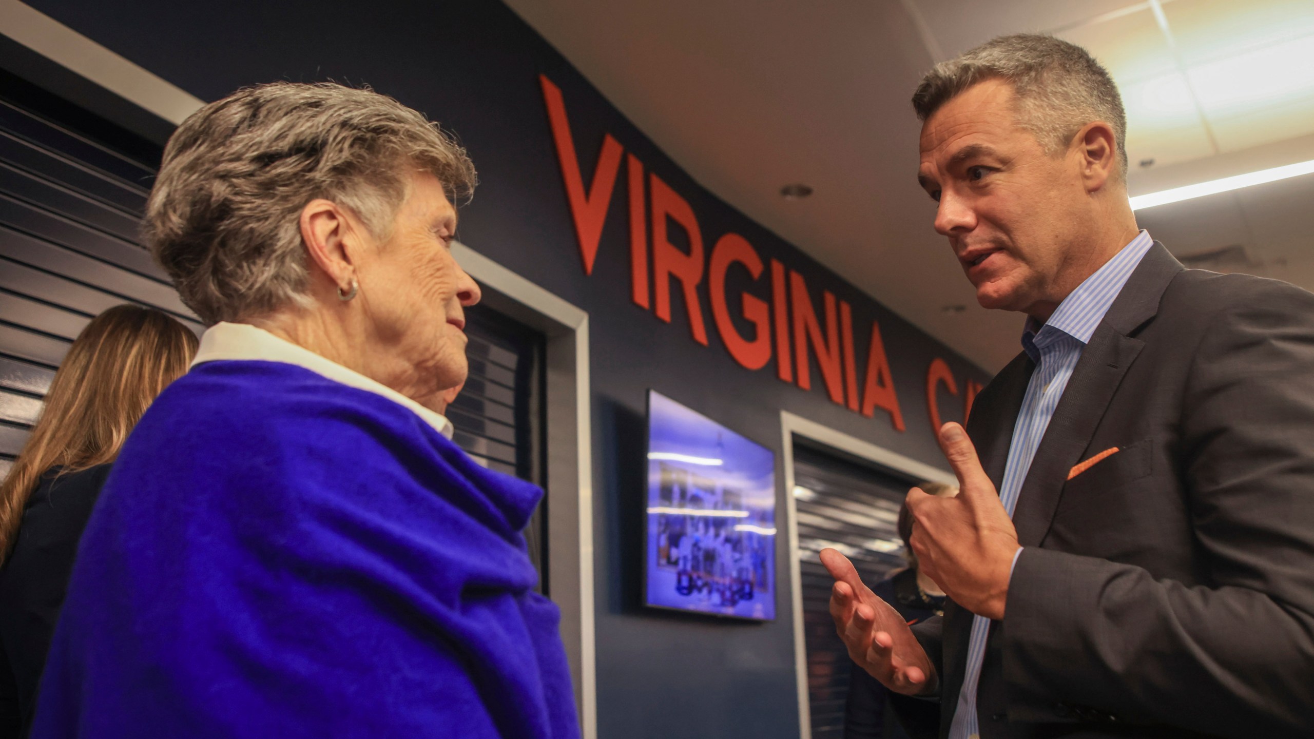 Pat Parkhill speaks with Virginia NCAA college basketball coach Tony Bennett after Bennett announced his retirement in Charlottesville, Va., Friday, Oct. 18, 2024. (Cal Cary/The Daily Progress via AP)