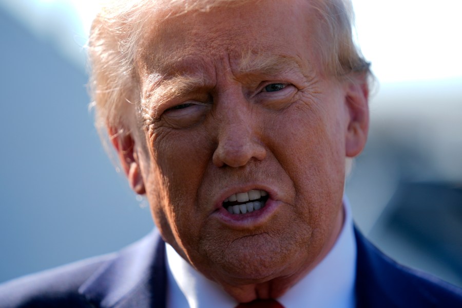 Republican presidential nominee former President Donald Trump speaks to reporters as he arrives at Detroit Metropolitan Wayne County Airport, Friday, Oct. 18, 2024, in Detroit. (AP Photo/Evan Vucci)