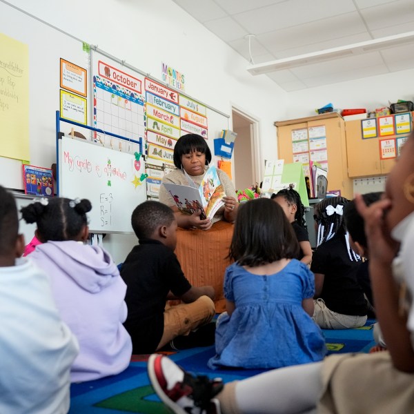 Preschool teacher Bridget Jeffreys reads to students, Thursday, Oct. 3, 2024, at Dorothy I. Height Elementary School in Baltimore. (AP Photo/Stephanie Scarbrough)