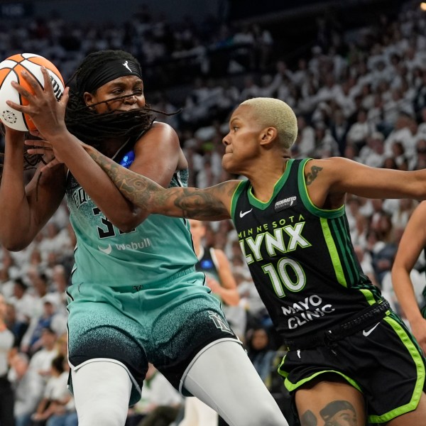 Minnesota Lynx guard Courtney Williams (10) reaches in against New York Liberty forward Jonquel Jones during the first half of Game 4 of a WNBA basketball final playoff series, Friday, Oct. 18, 2024, in Minneapolis. (AP Photo/Abbie Parr)