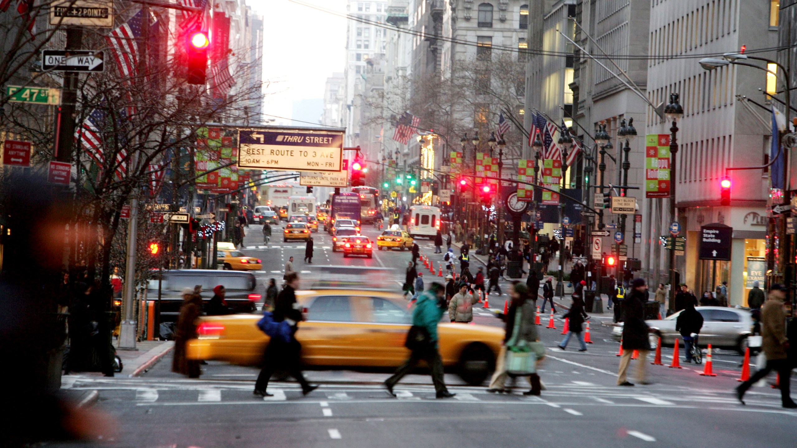 FILE - Vehicles and pedestrians make their way down Fifth Avenue in New York, Dec. 22, 2005, . (AP Photo/Diane Bondareff, File)