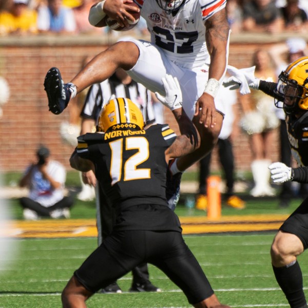 Auburn running back Jarquez Hunter, top, leaps over Missouri cornerback Dreyden Norwood during the first half of an NCAA college football game Saturday, Oct. 19, 2024, in Columbia, Mo. (AP Photo/L.G. Patterson)