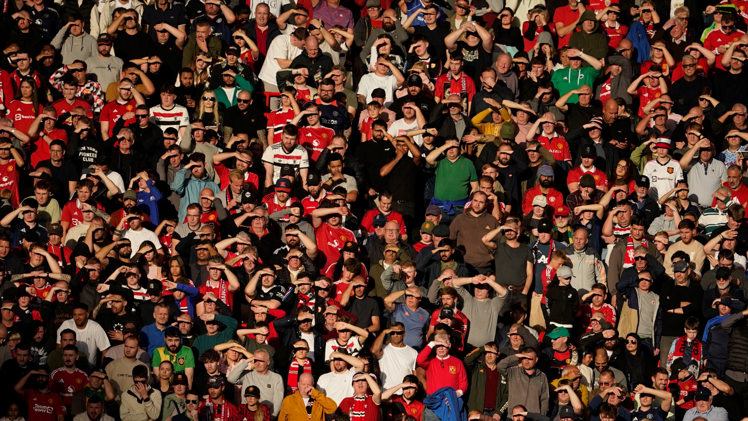 Fans watch from the stands during the English Premier League soccer match between Manchester United and Brentford at Old Trafford stadium in Manchester, England, Saturday, Oct. 19, 2024. (AP Photo/Dave Thompson)