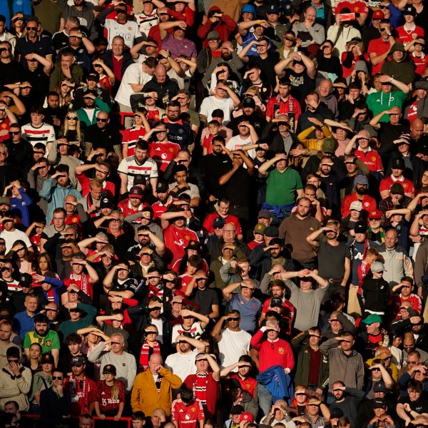 Fans watch from the stands during the English Premier League soccer match between Manchester United and Brentford at Old Trafford stadium in Manchester, England, Saturday, Oct. 19, 2024. (AP Photo/Dave Thompson)