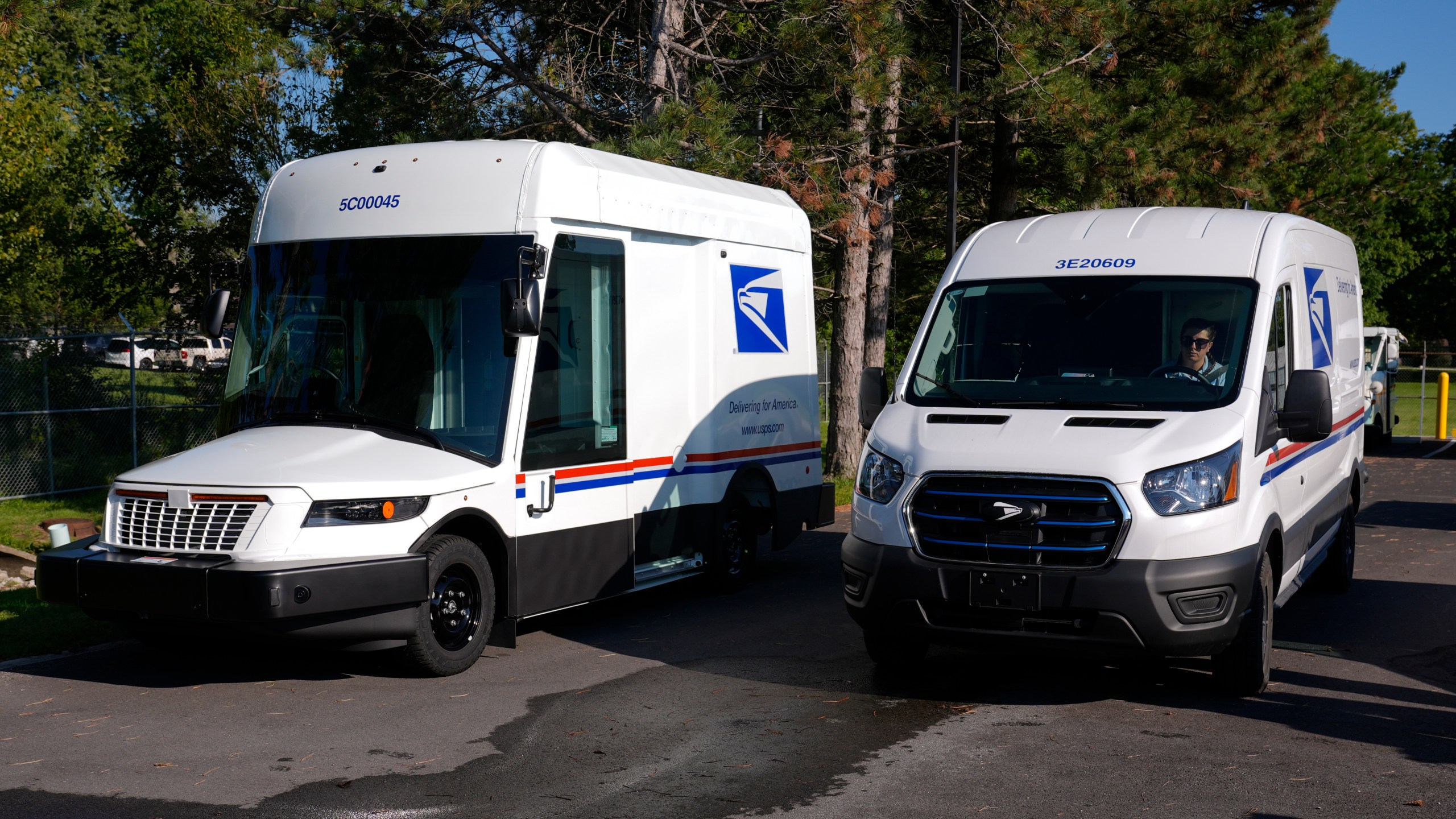 FILE - The U.S. Postal Service's next-generation delivery vehicle, left, is displayed as one new battery electric delivery trucks leaves the Kokomo Sorting and Delivery Center in Kokomo, Ind., Thursday, Aug. 29, 2024. (AP Photo/Michael Conroy, File)