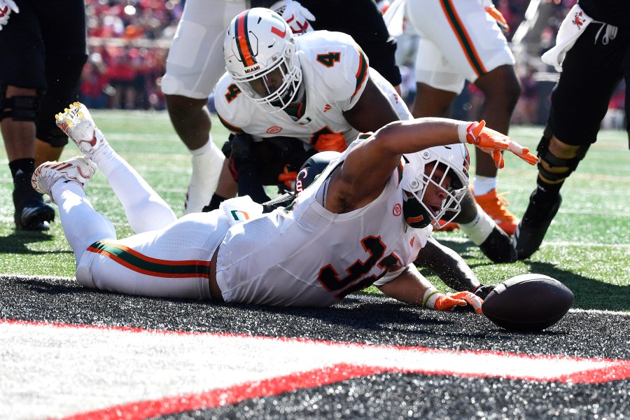 Miami linebacker Raul Aguirre Jr. (32) recovers a Louisville fumble in the end zone to score during the first half of an NCAA college football game in Louisville, Ky., Saturday, Oct. 19, 2024. (AP Photo/Timothy D. Easley)