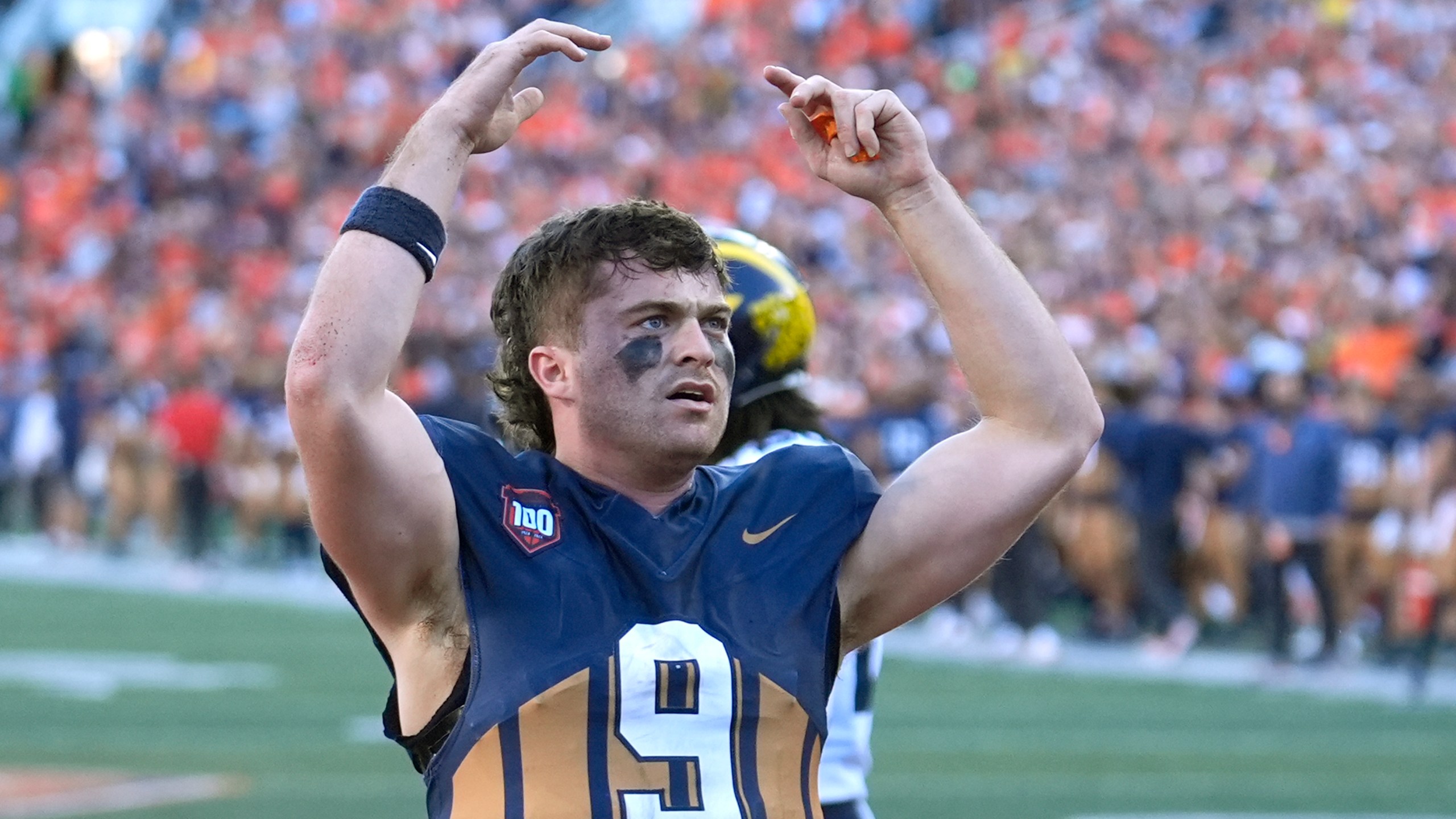 Illinois quarterback Luke Altmyer celebrates his touchdown during the second half of an NCAA college football game against Michigan on Saturday, Oct. 19, 2024, in Champaign, Ill. (AP Photo/Charles Rex Arbogast)