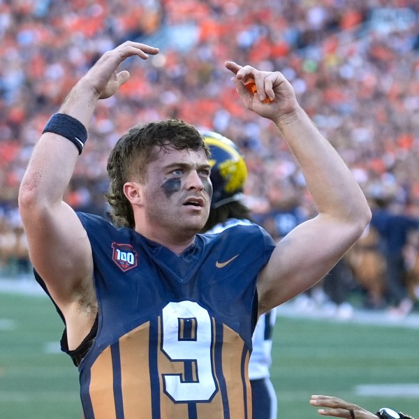 Illinois quarterback Luke Altmyer celebrates his touchdown during the second half of an NCAA college football game against Michigan on Saturday, Oct. 19, 2024, in Champaign, Ill. (AP Photo/Charles Rex Arbogast)