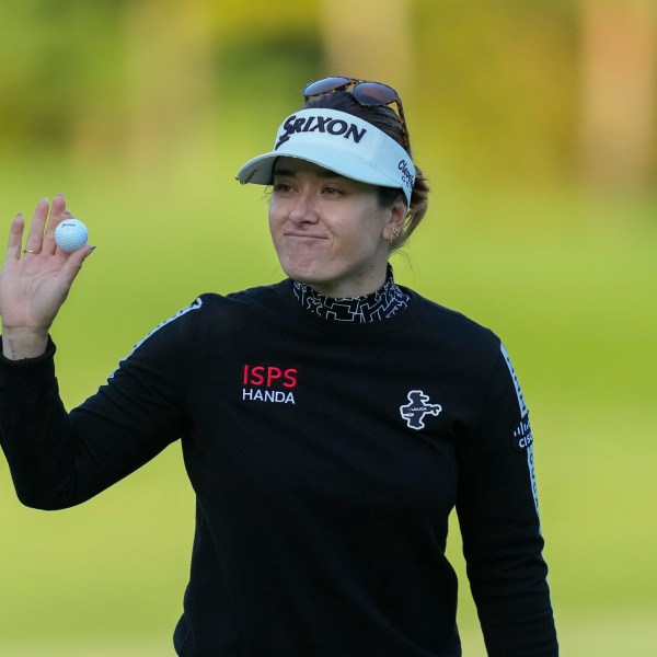 Hannah Green of Australia celebrates on the 18th hole after winning the LPGA Ladies Championship golf tournament at the Seowon Valley Country Club in Paju, South Korea, Sunday, Oct. 20, 2024. (AP Photo/Lee Jin-man)