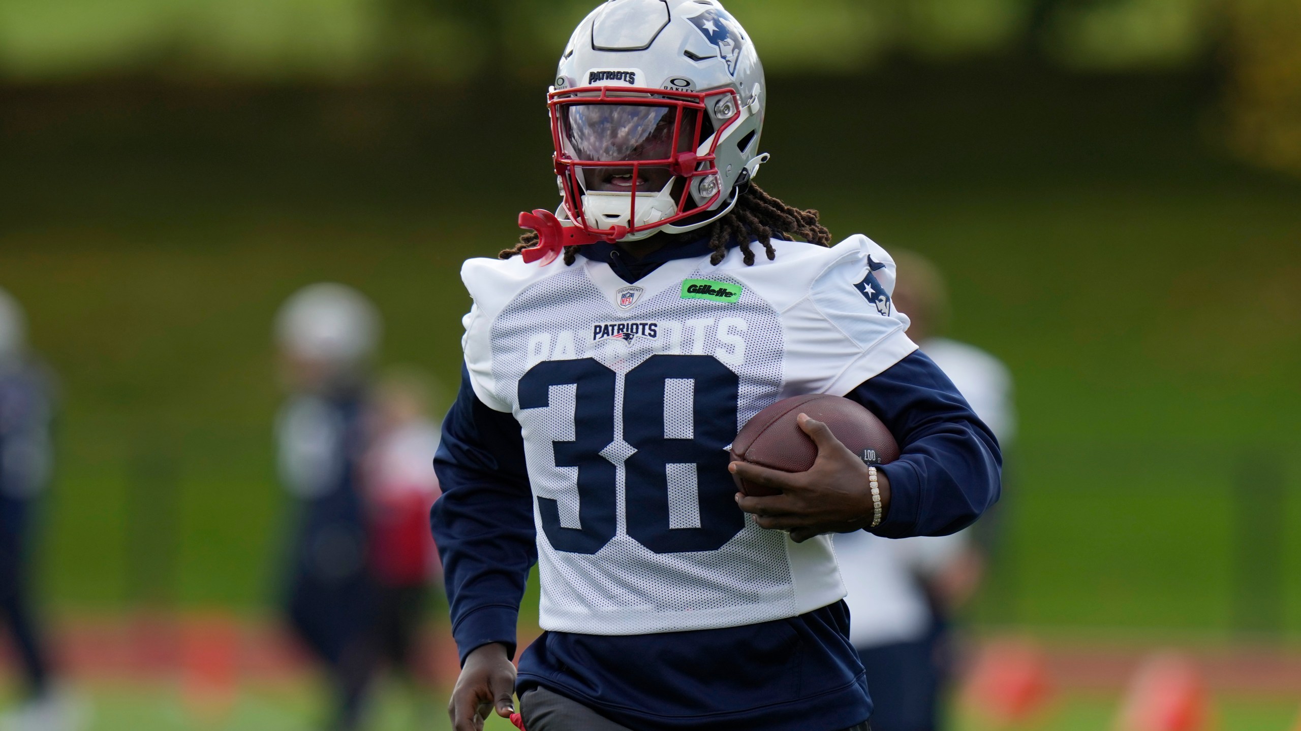 New England Patriots running back Rhamondre Stevenson (38) takes part in drills during NFL football practice, Friday, Oct. 18, 2024, in Harrow, England. (AP Photo/Steve Luciano)