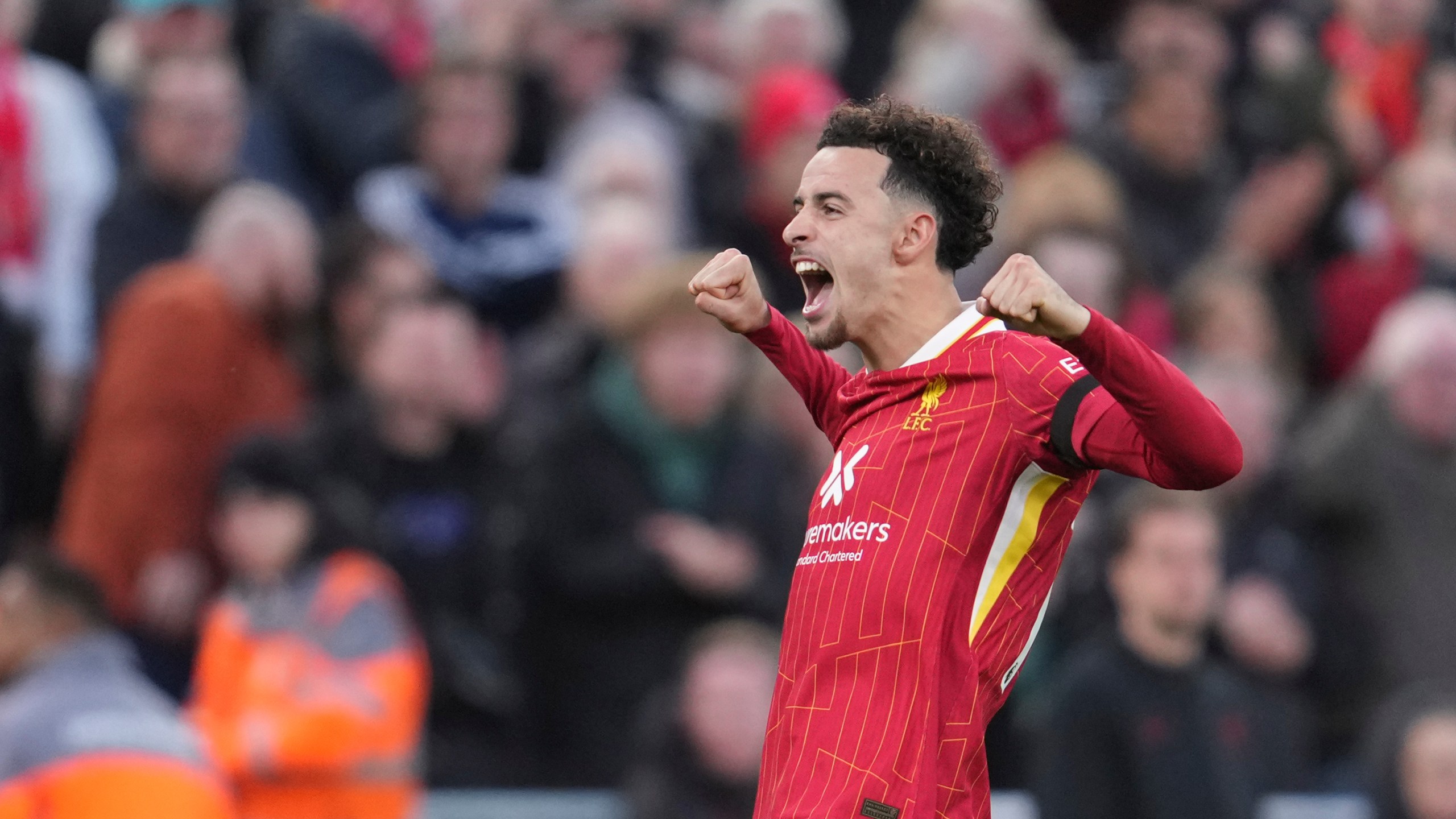 Liverpool's Curtis Jones celebrates after scoring his side's second goal during the English Premier League soccer match between Liverpool and Chelsea at Anfield Stadium, Liverpool, England, Sunday, Oct. 20, 2024. (AP Photo/Jon Super)