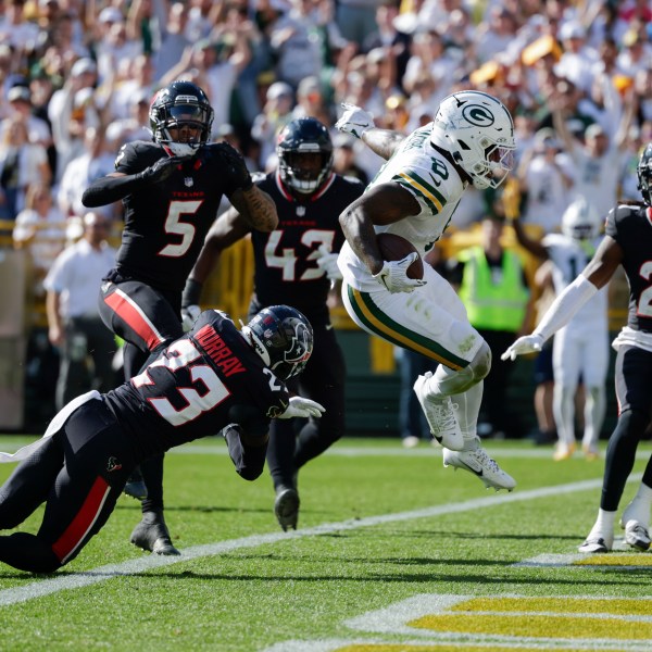 Green Bay Packers running back Josh Jacobs (8) scores a touchdown during the second half of an NFL football game against the Houston Texans, Sunday, Oct. 20, 2024, in Green Bay, Wis. (AP Photo/Matt Ludtke)