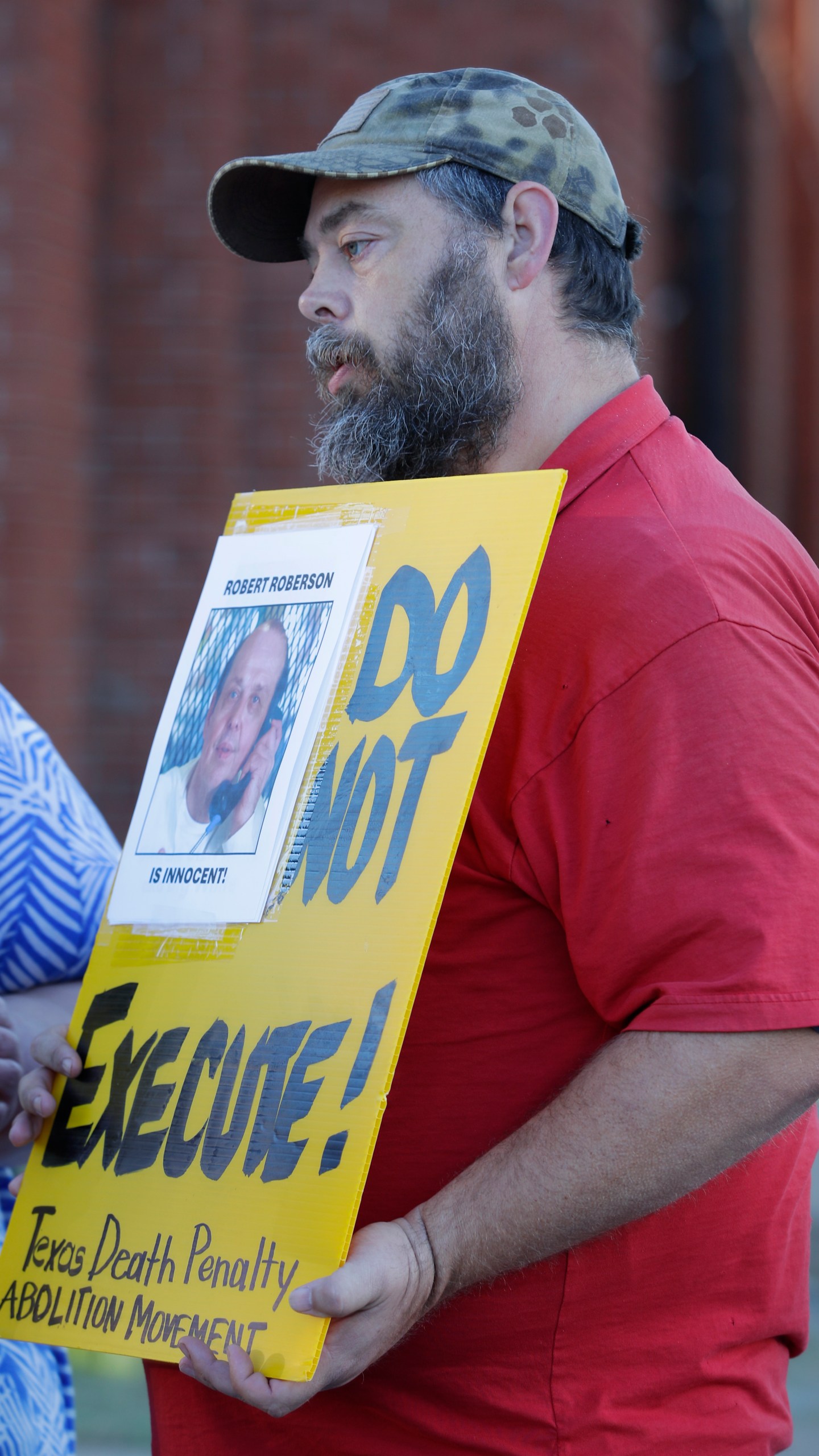 Thomas Roberson, older brother of condemned prisoner Robert Roberson, protests with others outside the prison where Roberson is scheduled for execution at the Huntsville Unit of the Texas State Penitentiary, Thursday, Oct. 17, 2024, in Huntsville, Texas. (AP Photo/Michael Wyke)