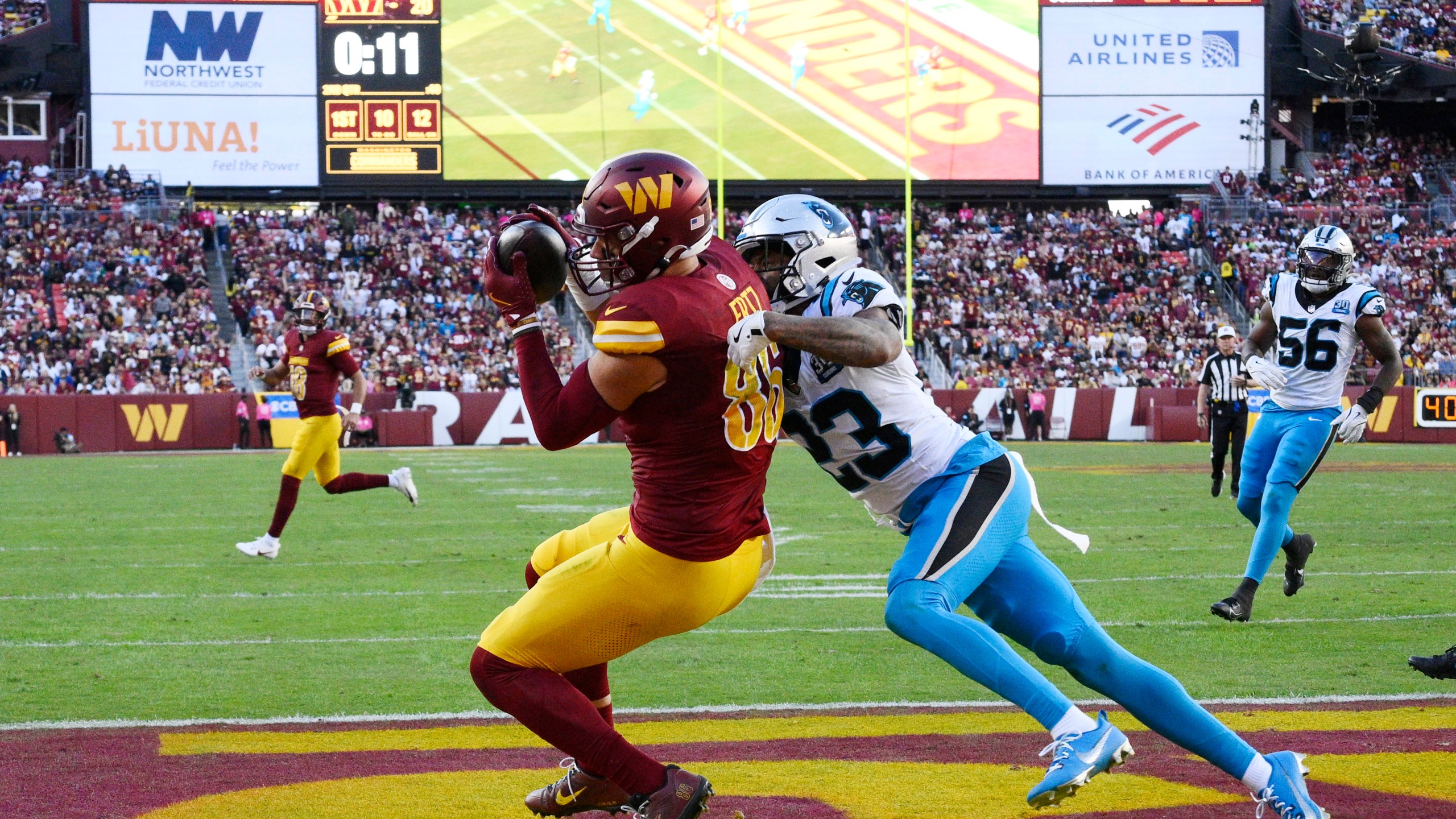 Washington Commanders tight end Zach Ertz (86) catches a 12-yard touchdown pass in front of Carolina Panthers cornerback Dane Jackson (23) during the first half of an NFL football game, Sunday, Oct. 20, 2024, in Landover, Md. (AP Photo/Nick Wass)