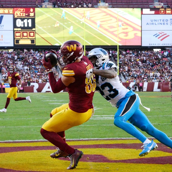 Washington Commanders tight end Zach Ertz (86) catches a 12-yard touchdown pass in front of Carolina Panthers cornerback Dane Jackson (23) during the first half of an NFL football game, Sunday, Oct. 20, 2024, in Landover, Md. (AP Photo/Nick Wass)