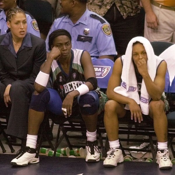 FILE - New York Liberty's Rebecca Lobo, left, Tari Phillips, center, and Teresa Weatherspoon watch from the bench in the final seconds against the Houston Comets in Game 2 of the WNBA Championship game, Aug. 26, 2000, in Houston. (AP Photo/Pat Sullivan, File)