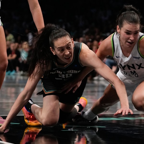 New York Liberty forward Breanna Stewart (30) and Minnesota Lynx forward Bridget Carleton (6) battle for a loose ball during the second quarter of Game 5 of the WNBA basketball final series, Sunday, Oct. 20, 2024, in New York. (AP Photo/Pamela Smith)