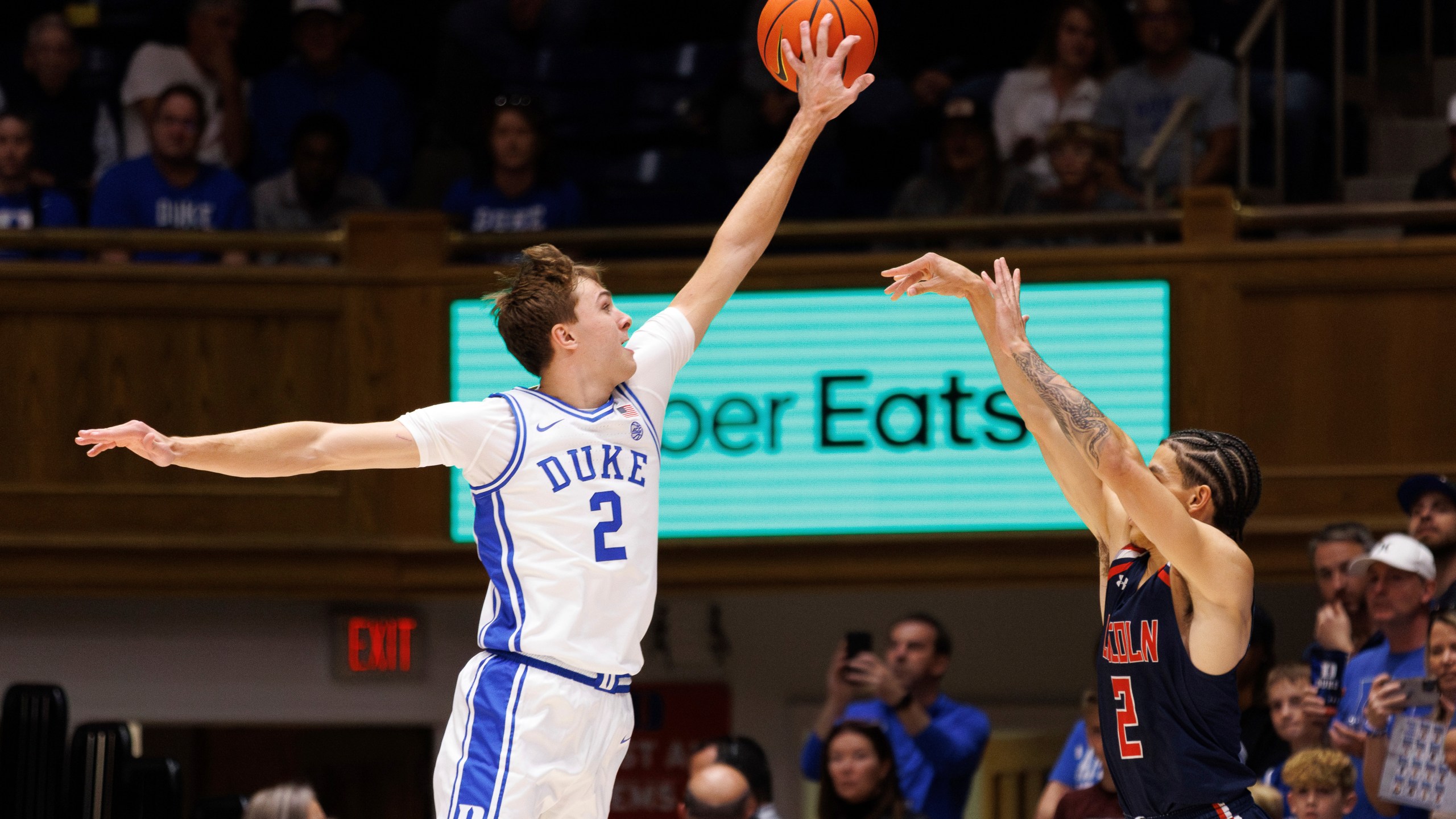 Duke's Cooper Flagg, left, blocks a shot from Lincoln's Freddie Young, right, during the first half of an exhibition NCAA college basketball game in Durham, N.C., Saturday, Oct. 19, 2024. (AP Photo/Ben McKeown)