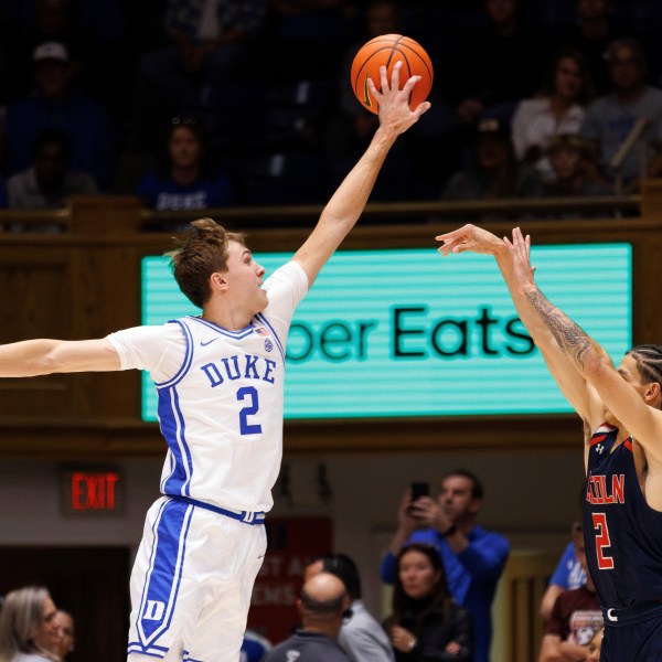 Duke's Cooper Flagg, left, blocks a shot from Lincoln's Freddie Young, right, during the first half of an exhibition NCAA college basketball game in Durham, N.C., Saturday, Oct. 19, 2024. (AP Photo/Ben McKeown)