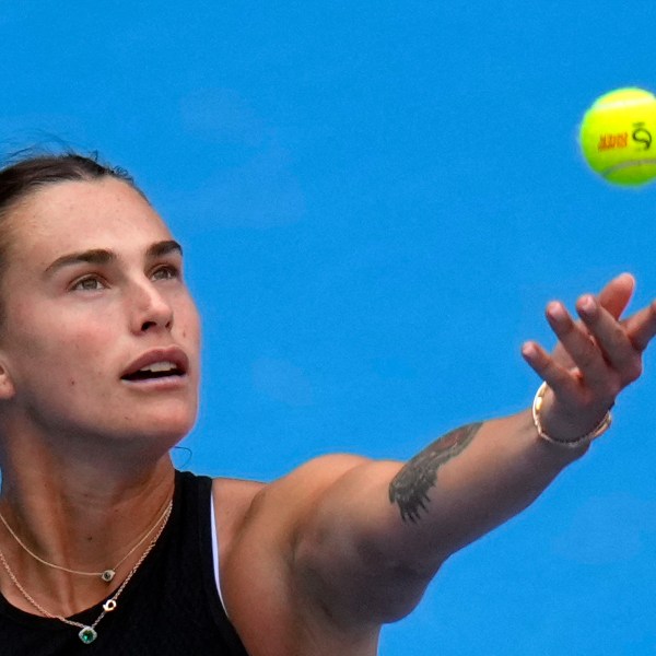 Aryna Sabalenka of Belarus tosses the ball to serve against Karolina Muchova of the Czech Republic during their women's singles quarterfinals match of the China Open tennis tournament, at the National Tennis Center in Beijing, Friday, Oct. 4, 2024. (AP Photo/Andy Wong)