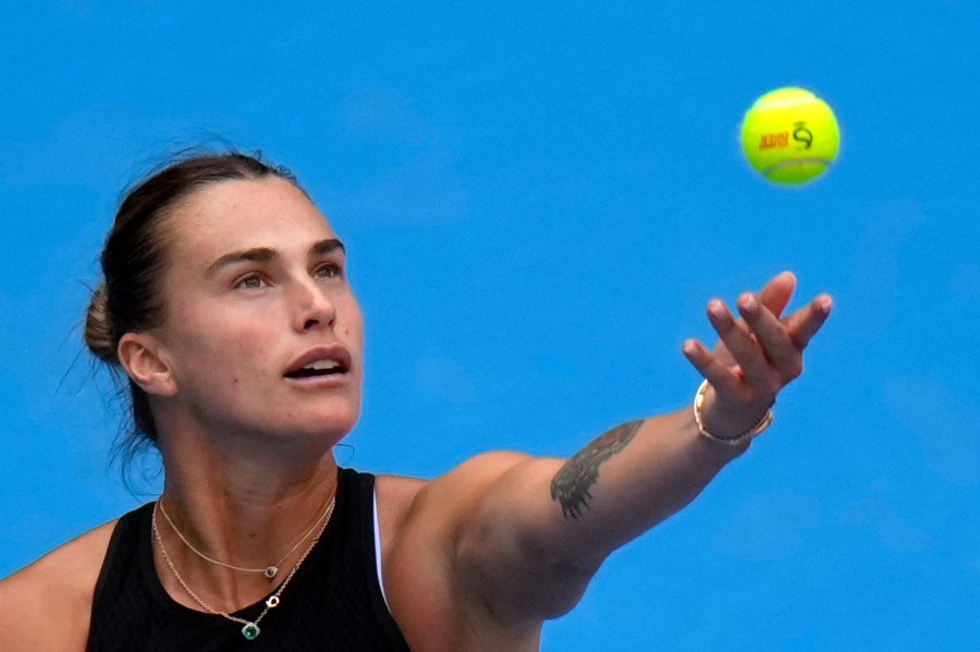 Aryna Sabalenka of Belarus tosses the ball to serve against Karolina Muchova of the Czech Republic during their women's singles quarterfinals match of the China Open tennis tournament, at the National Tennis Center in Beijing, Friday, Oct. 4, 2024. (AP Photo/Andy Wong)