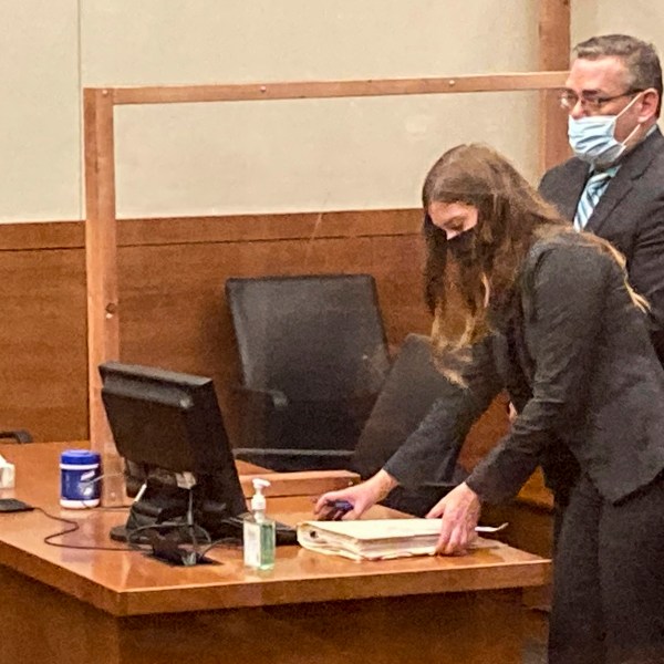 FILE - Former Ohio police officer Adam Coy stands during a Franklin County hearing as defense attorney Kaitlyn Stephens checks her notes, Oct. 4, 2021, in Columbus, Ohio. (AP Photo/Andrew Welsh-Huggins, File)