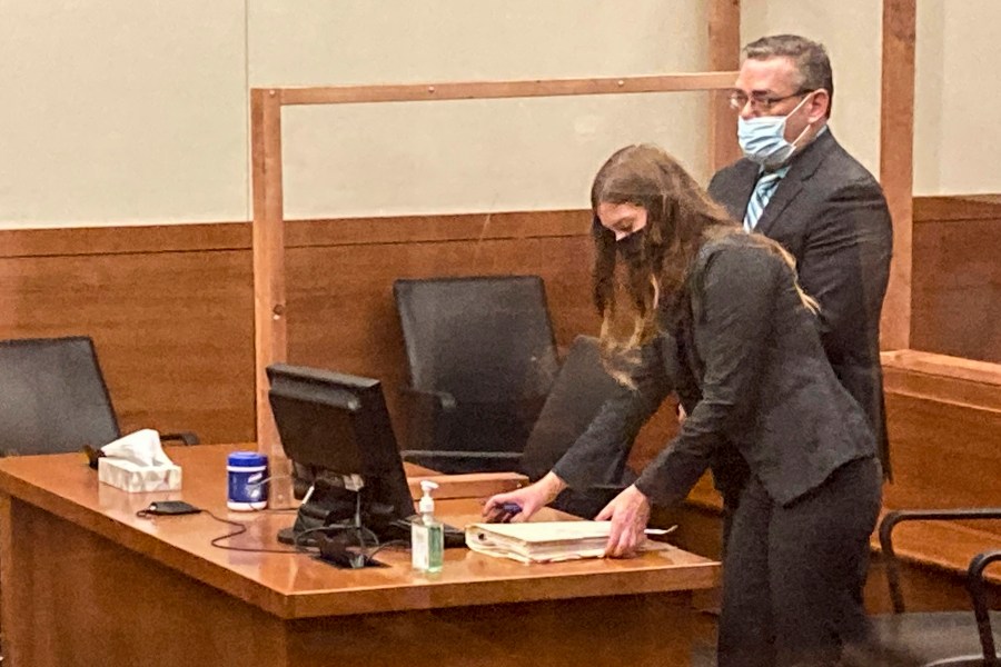 FILE - Former Ohio police officer Adam Coy stands during a Franklin County hearing as defense attorney Kaitlyn Stephens checks her notes, Oct. 4, 2021, in Columbus, Ohio. (AP Photo/Andrew Welsh-Huggins, File)