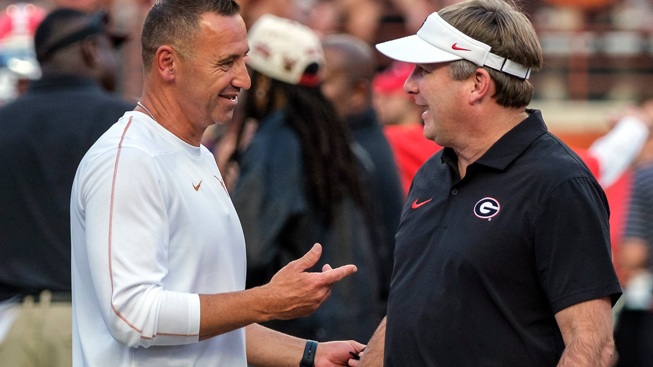 Texas head coach Steve Sarkisian, left, and Georgia head coach Kirby Smart talk during the pregame of an NCAA college football game in Austin, Texas, Saturday, Oct. 19, 2024. (AP Photo/Rodolfo Gonzalez)