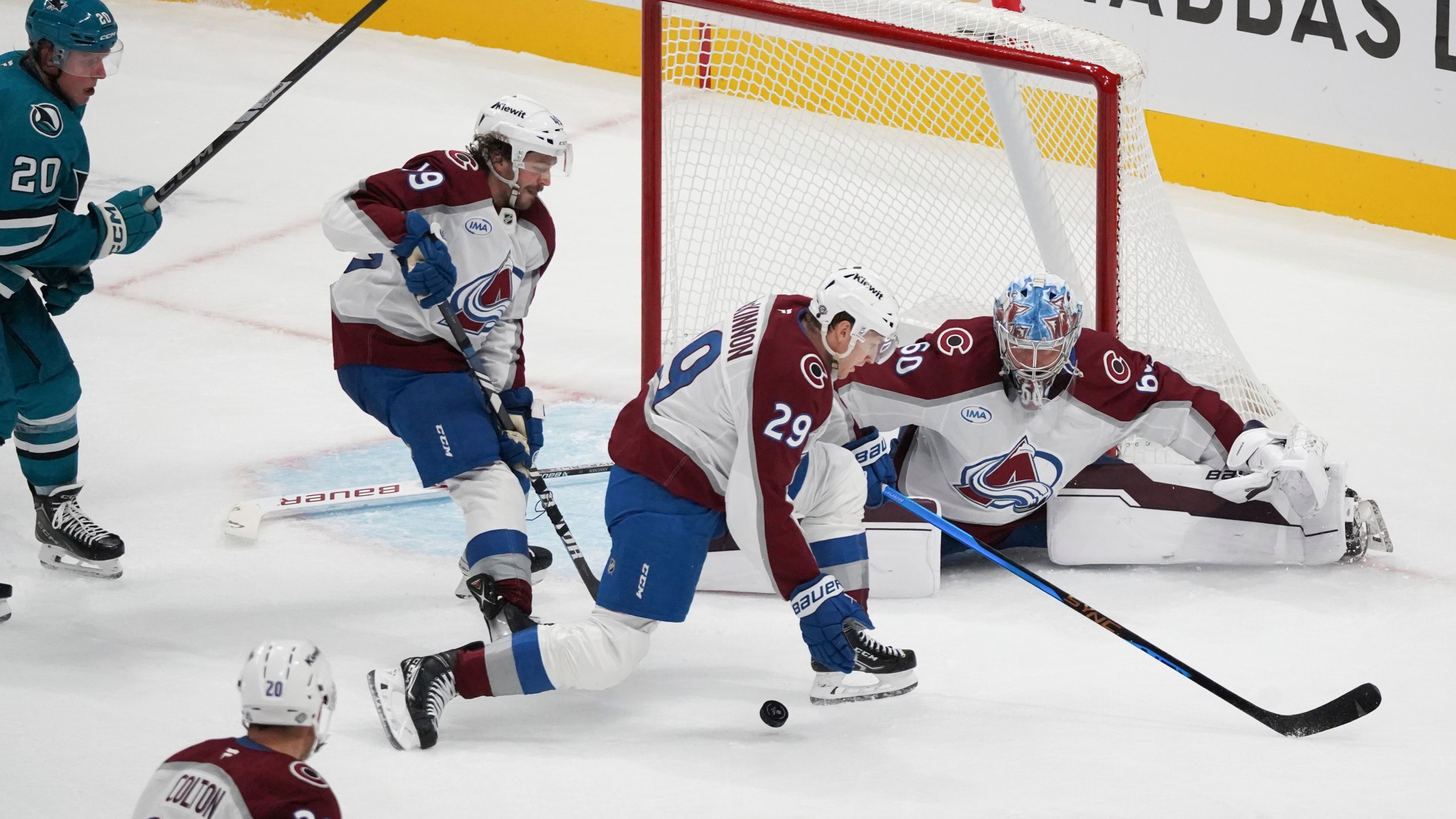 Colorado Avalanche players Samuel Girard (49), center left, Nathan MacKinnon (29), center right, and Justus Annunen (60), far right, defend a shot as San Jose Sharks left wing Fabian Zetterlund (20) looks to score during the third period of an NHL hockey game in San Jose, Calif., Sunday, Oct. 20, 2024. (AP Photo/Minh Connors)